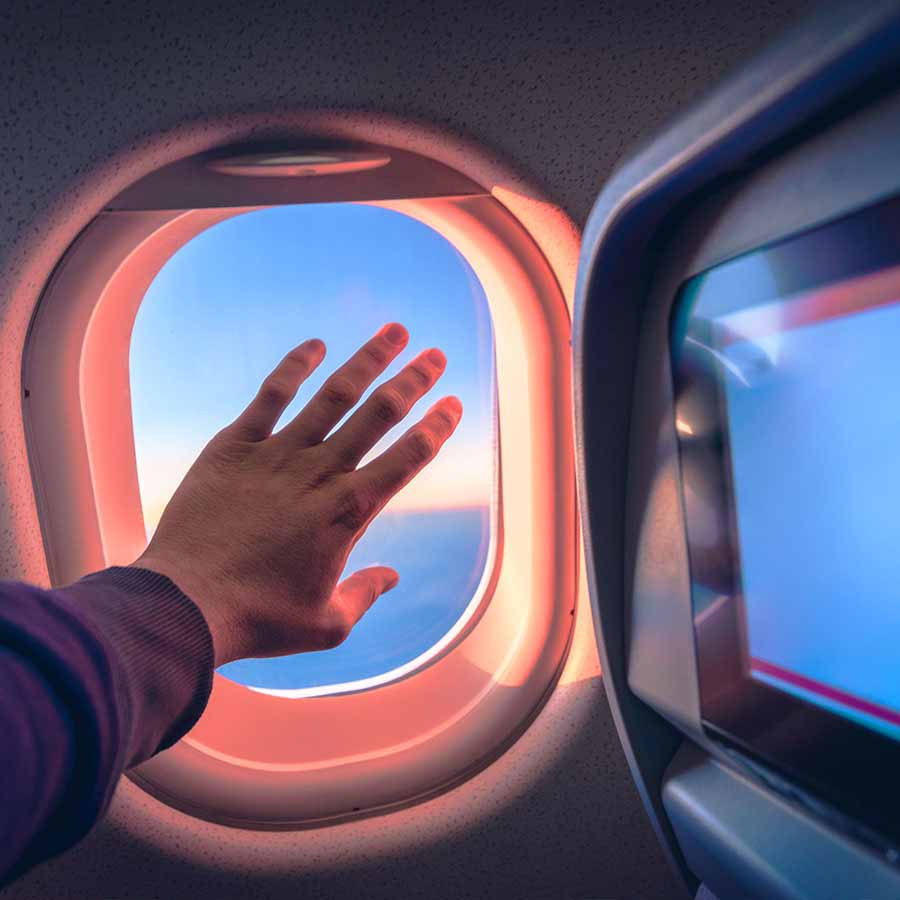 Person touching airplane window