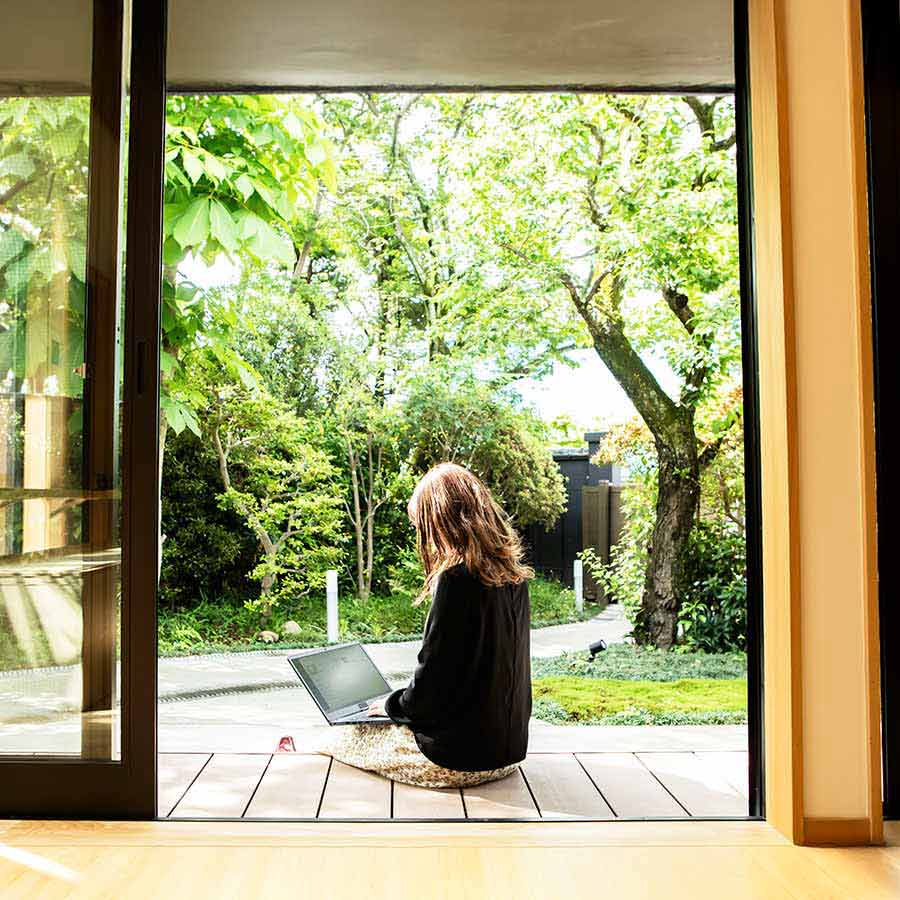 Person working on laptop near window